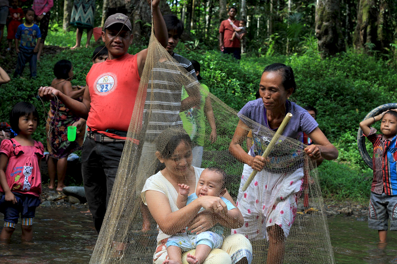 Mandi Anak adalah salah satu upacara adat orang Sungkup untuk kali pertama memandikan anak di sungai dan menjadi simbol interaksi yang harmonis dengan alam (sungai). Foto: Andi Fachrizal
