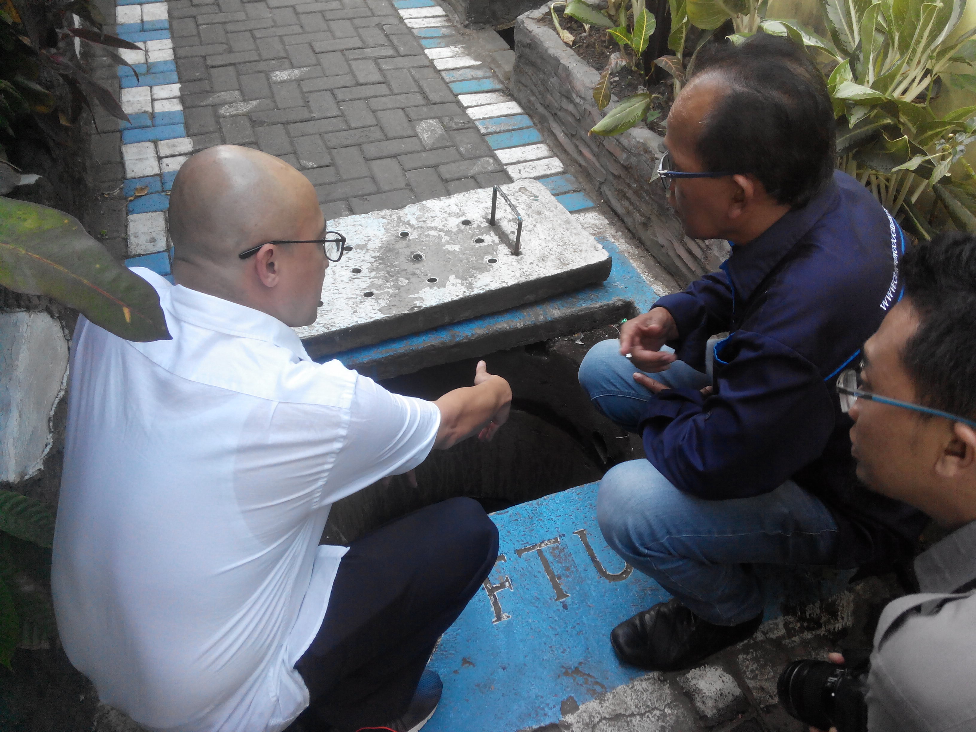 Direktur Utama Perum Jasa Tirta 1, Raymond Valiant Ruritan (baju putih) bersama Bambang Irianto memeriksa sumur injeksi di Kampung Glintung | Foto: Eko Widianto/ Mongabay Indonesia